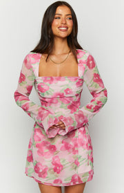 Square neckline and ruched bodice detail of a pink floral long sleeve mini dress with flared cuffs