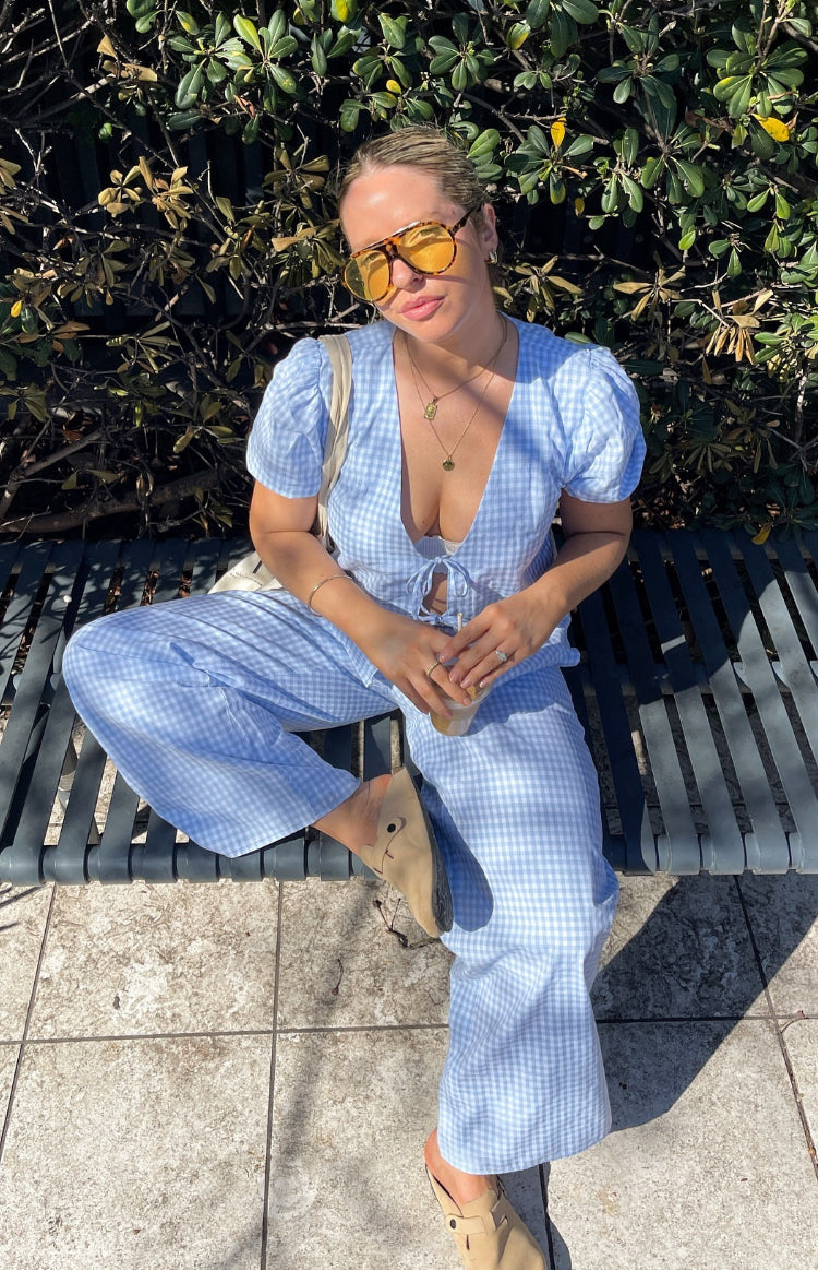 Light blue gingham tie-up top with deep V-neck, puff sleeves, and cropped hem