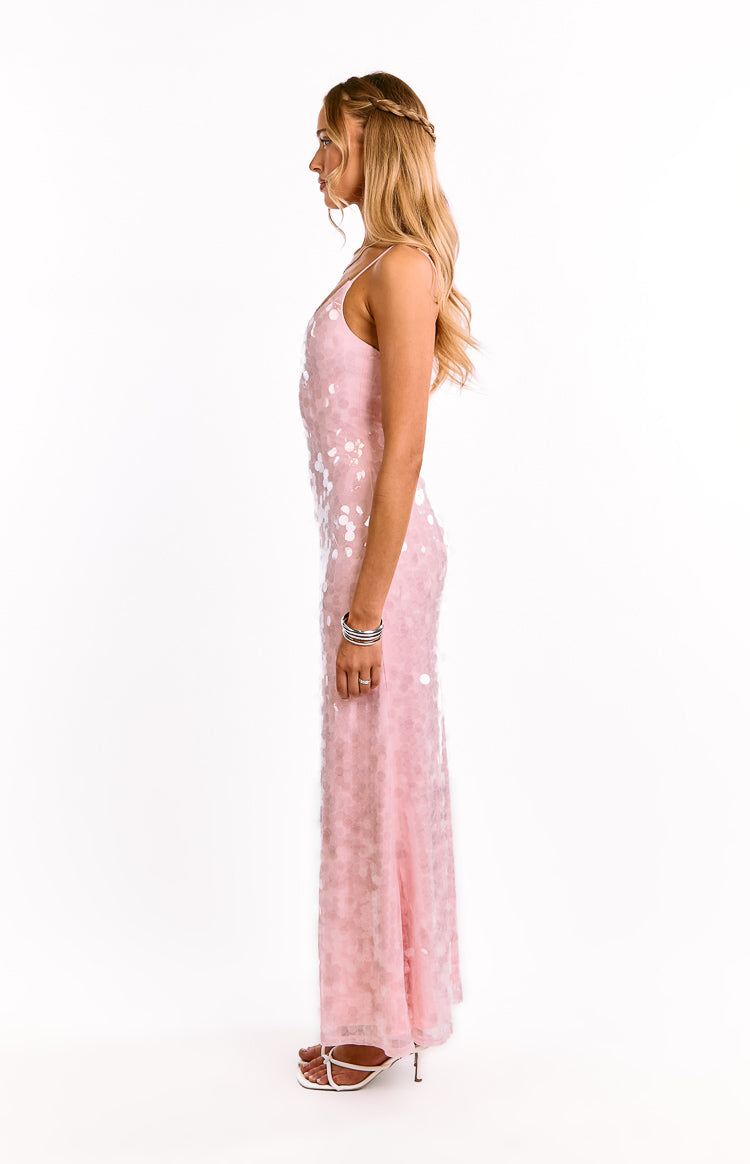 Side view of a pink sequin maxi dress with thin spaghetti straps and a flowing skirt