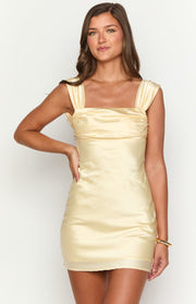 Yellow satin mini dress with a square neckline, wide gathered straps, and a ruched bust