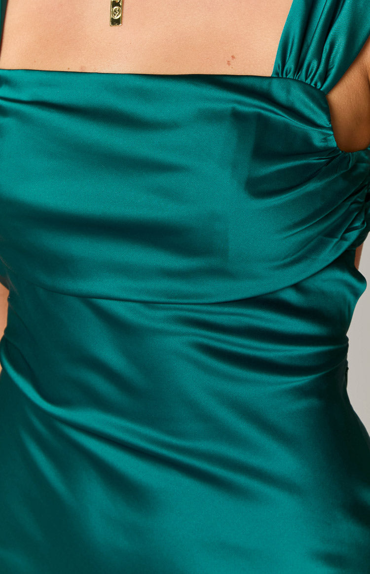 Close-up of the emerald satin mini dress bodice with square neckline and ruched wide straps