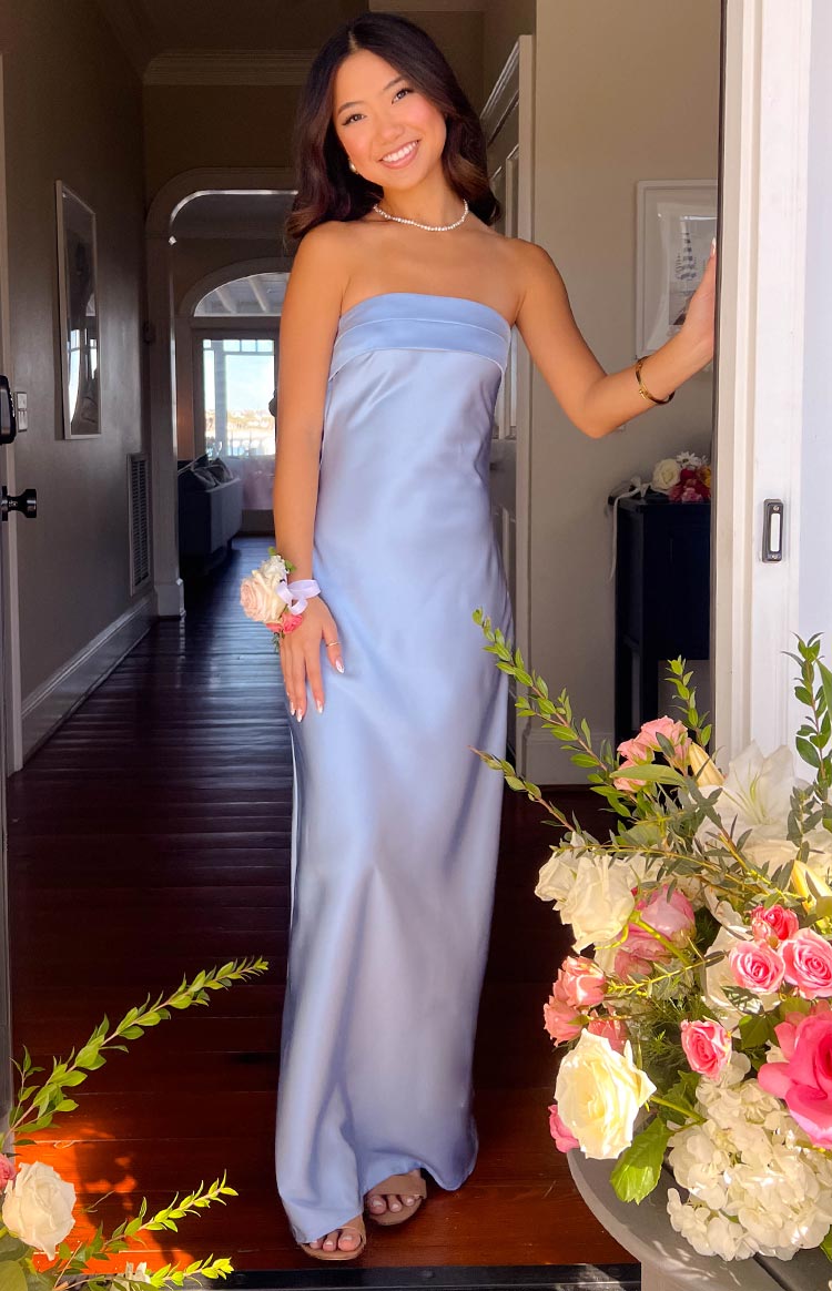 Full front view of a light blue strapless maxi dress with a smooth, flowing skirt and a folded band at the bust