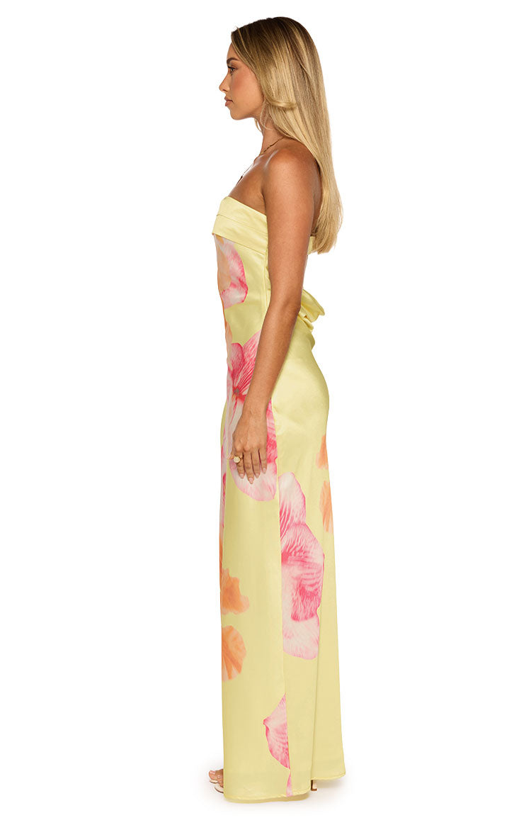 Side view of a yellow strapless maxi dress with pink hibiscus print, showing the straight neckline and back tie