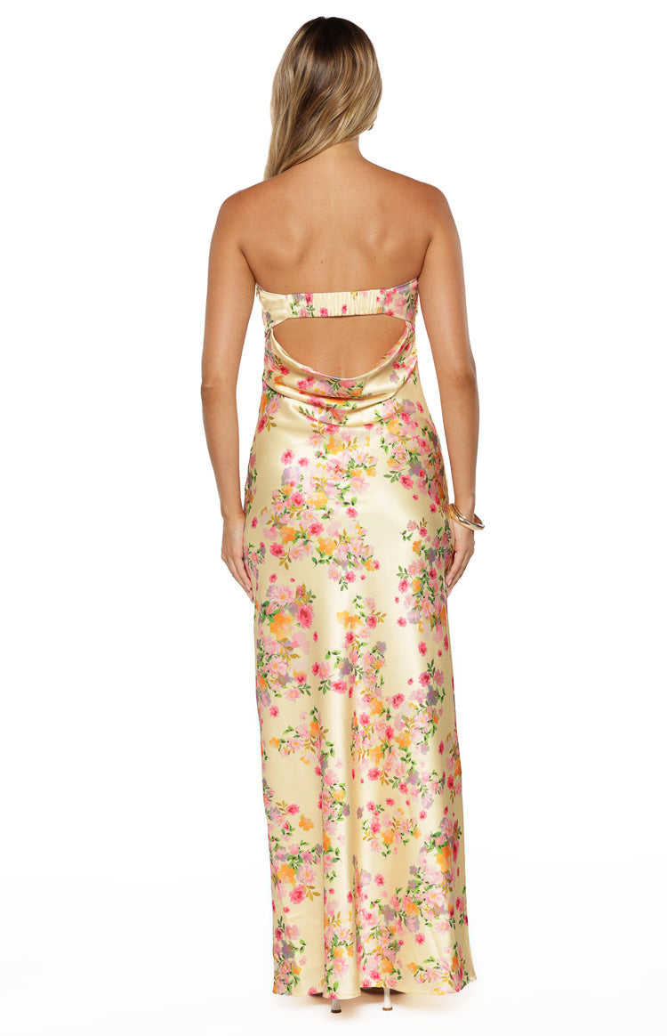 Back view of the yellow floral strapless maxi dress showing the elasticated band and cutout detail