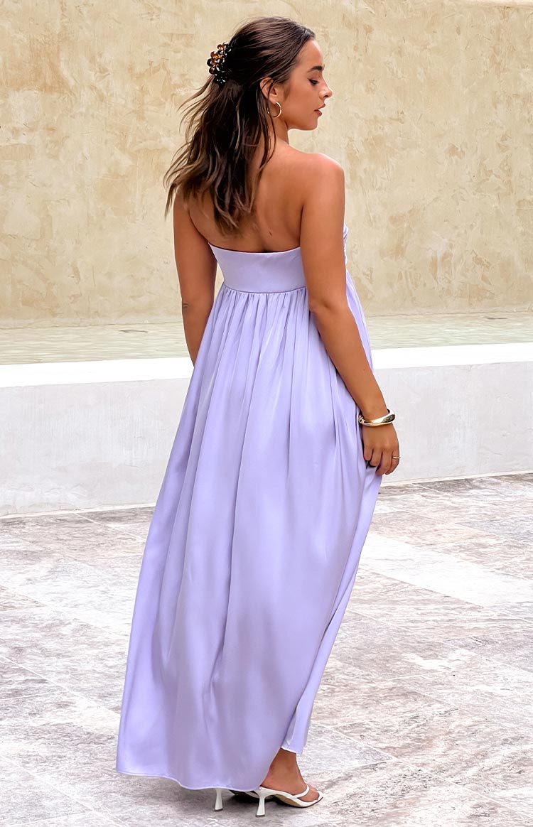 Rear view of a lilac strapless maxi dress with a gathered waist and flowy skirt