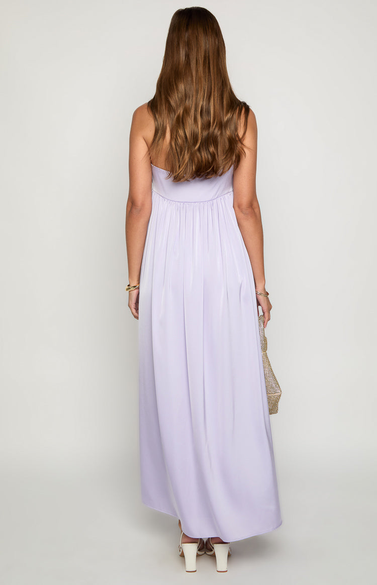 Rear view of a lilac strapless maxi dress with a shirred back bodice and flowy skirt
