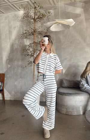 Front view of a white and navy stripe cropped knit sweater with a polo collar, button placket, and short sleeves