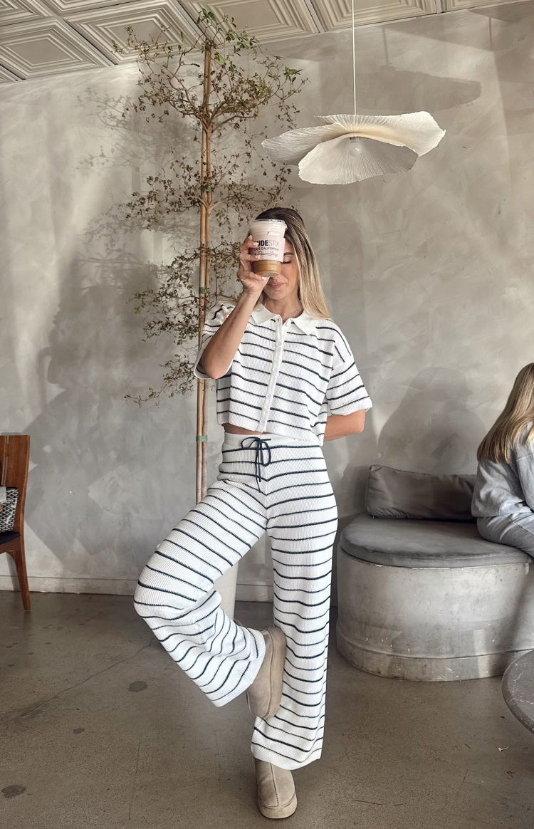 Front view of a white and navy stripe cropped knit sweater with a polo collar, button placket, and short sleeves