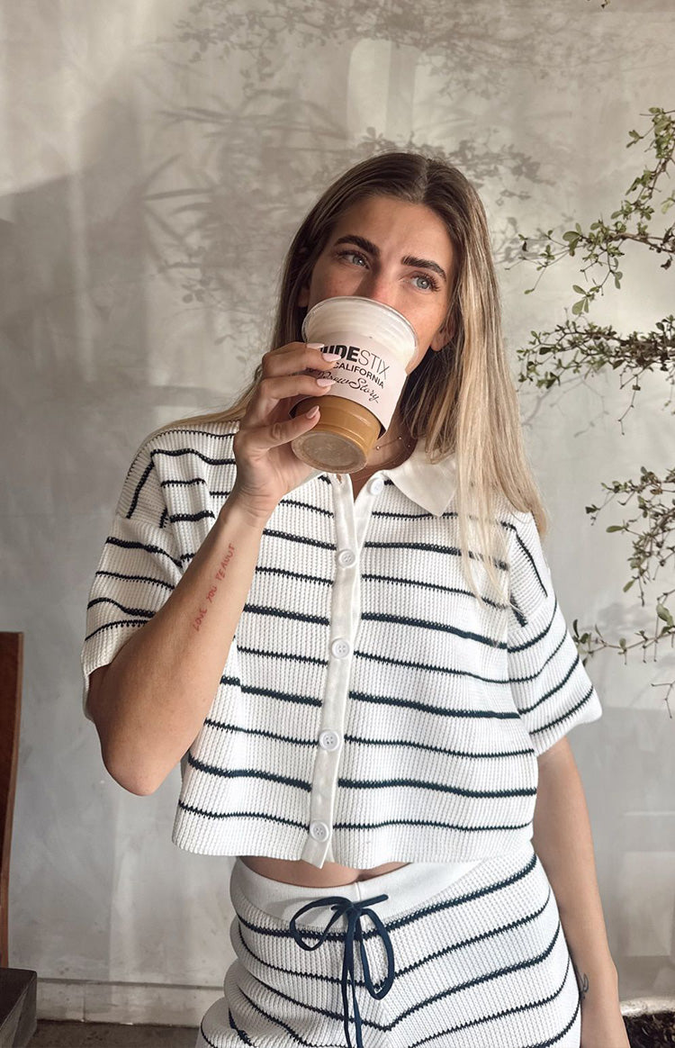 White and navy stripe cropped knit sweater with a collar, short sleeves, and button-front placket