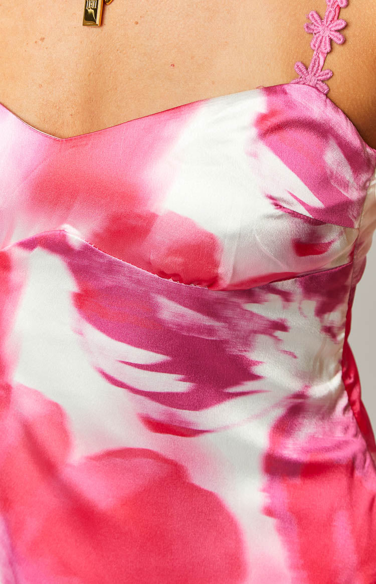 Close-up of the pink and white floral satin print dress with sweetheart neckline and embroidered floral strap