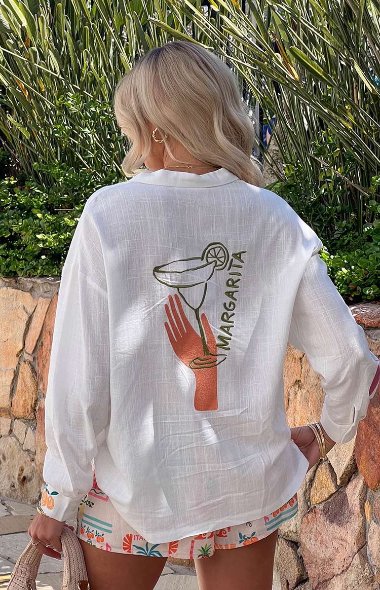 Beginning Boutique Margarita Dolce Vita Long Sleeve Shirt white long sleeve shirt with a back margarita glass and hand graphic