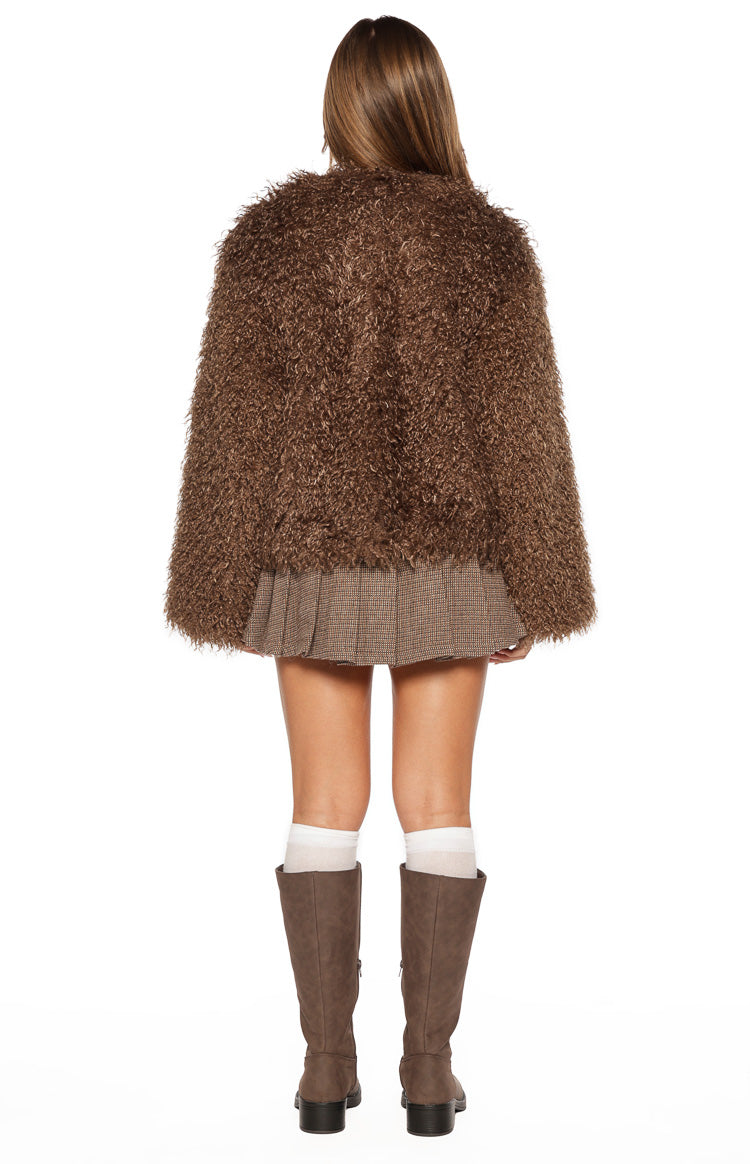 Rear view of the brown shaggy fur jacket, showing its textured back and cropped hem