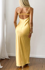 Rear view of a yellow satin midi dress with a low scoop back, thin spaghetti straps, and a back clasp closure
