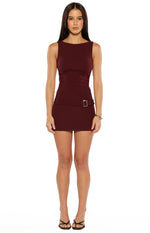 Burgundy sleeveless micro mini dress with a boat neck and square buckle detail on the hip