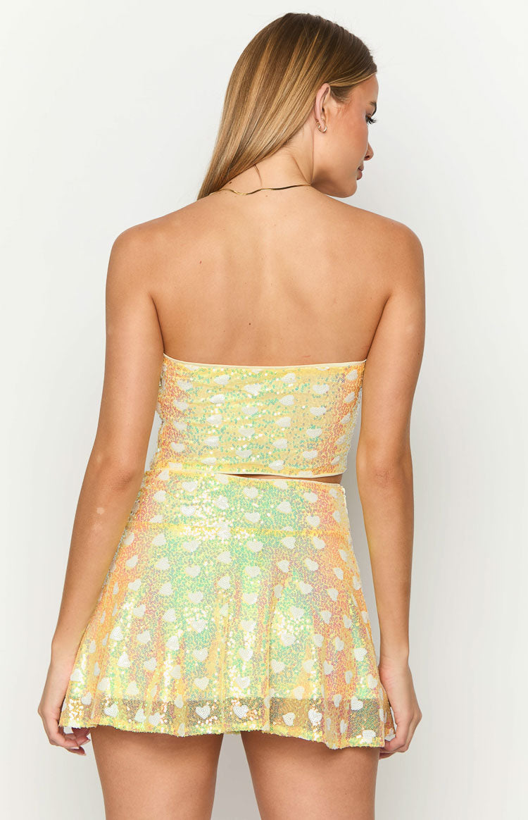 Rear view of the yellow sequin strapless corset top with a heart pattern