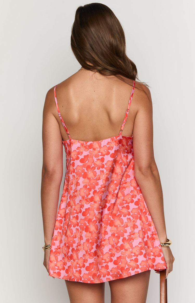 Rear view of a pink mini dress with orange floral print, showing the straight back neckline and thin adjustable spaghetti straps