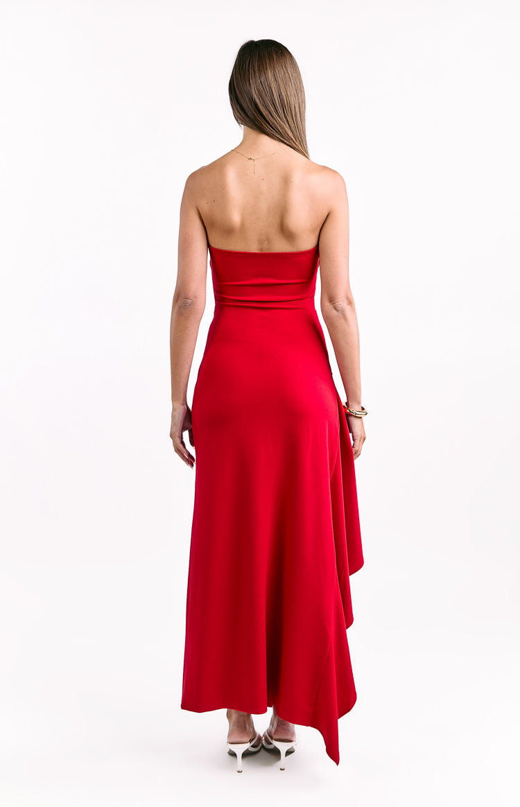 Rear view of a red strapless maxi dress with a fitted bodice and an asymmetrical hem