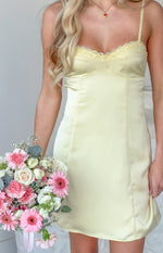 Yellow satin mini dress bodice with delicate lace trim, thin spaghetti straps, and fitted paneling