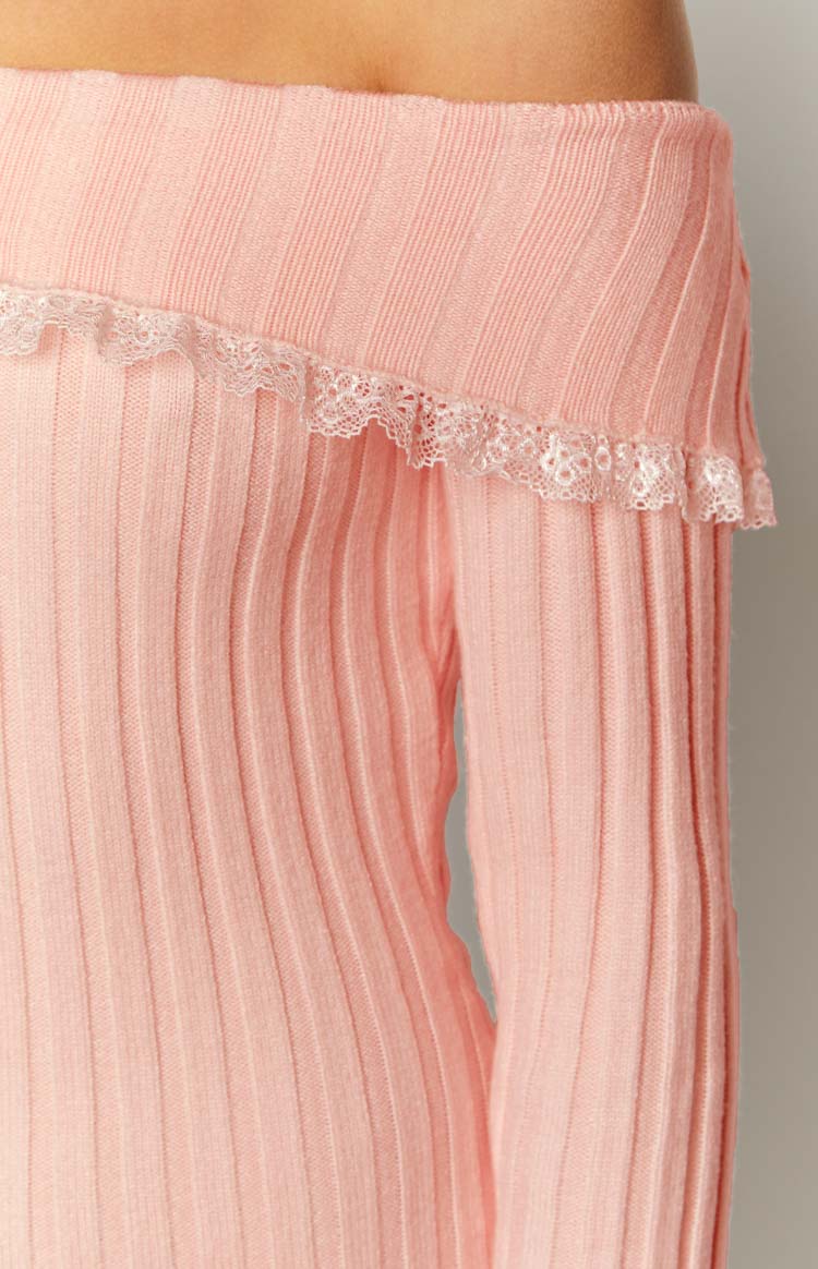 Close-up of the pink ribbed knit off-shoulder neckline with delicate white lace trim on a mini dress