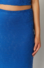 Close-up of the intricate floral lace pattern and texture of the blue maxi skirt