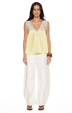 Yellow satin top with white lace trim on the V-neckline and shoulder straps, featuring a relaxed flowy fit