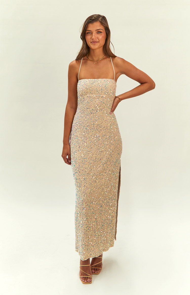 Full length view of a bodycon gold sequin maxi dress with a straight neckline, thin spaghetti straps, and a side slit