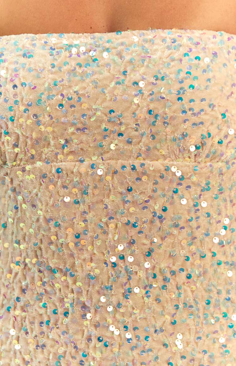 Close-up of the gold velvet fabric with iridescent sequins and a horizontal seam