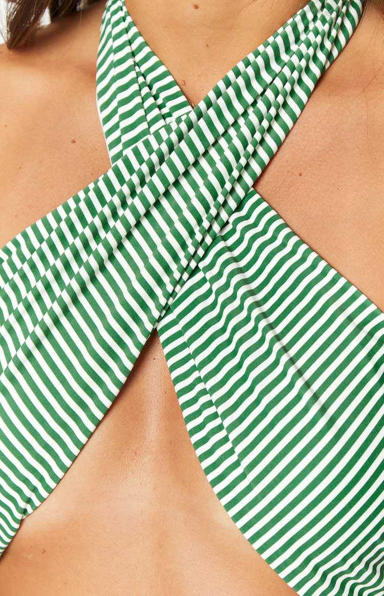 Close-up of the green and white striped criss-cross halter neckline of the bikini top