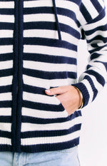 Close-up of the front zipper and side pocket on a navy and white stripe knit sweater