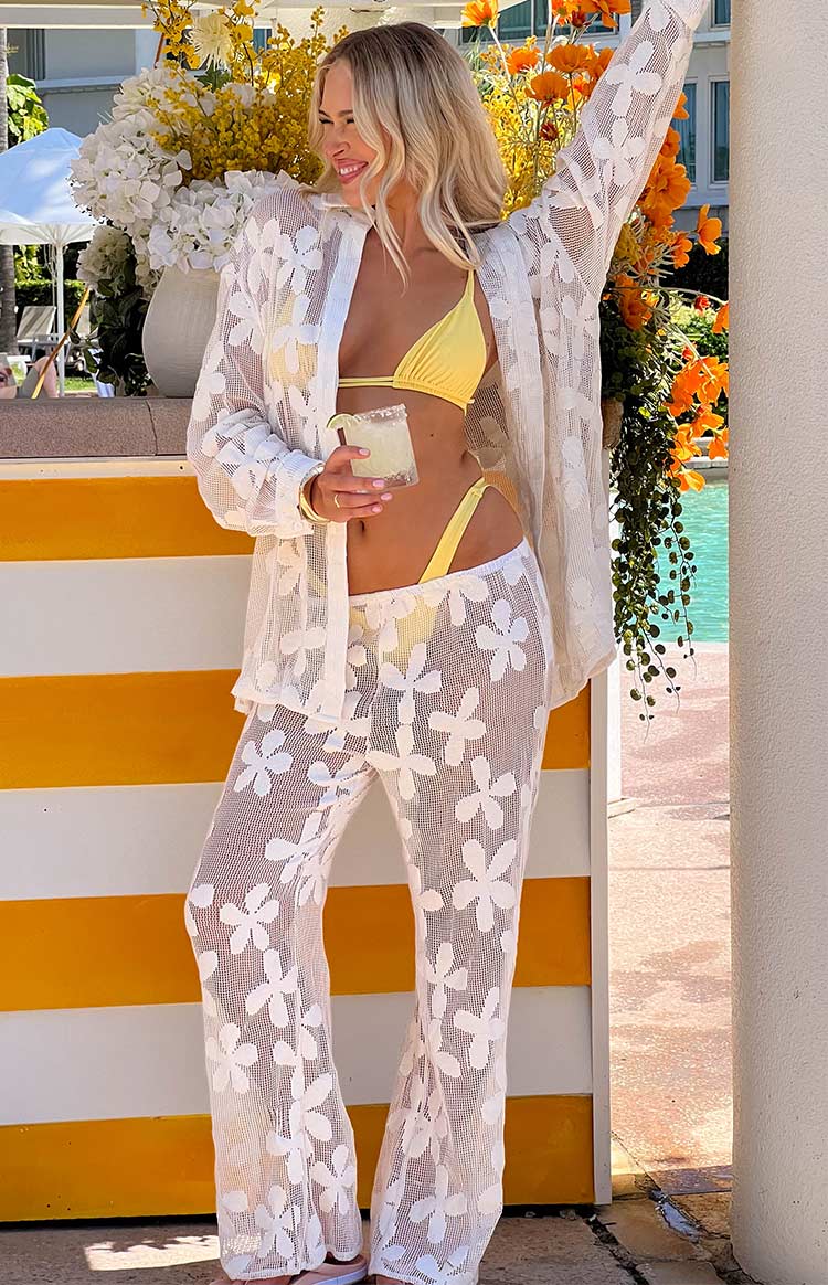 Full length view of white sheer floral mesh wide-leg pants