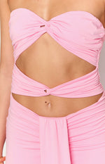 Close-up of the pink twisted fabric details and cutouts on the midriff of the maxi dress