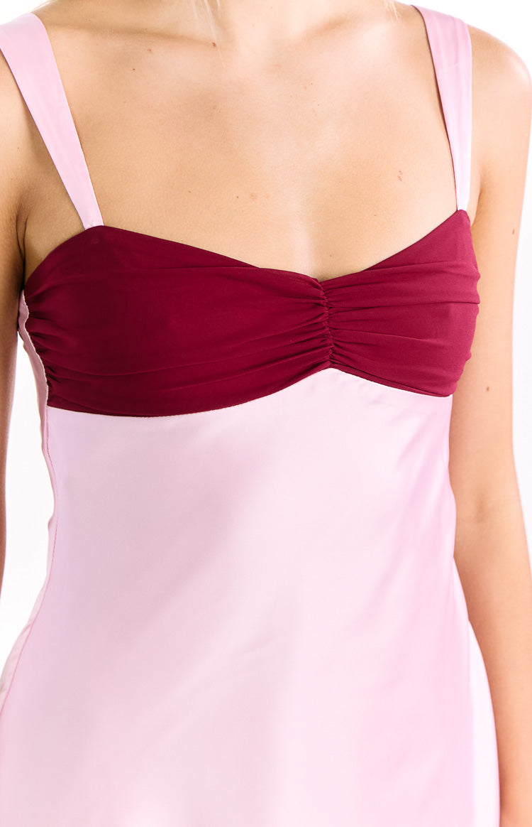 Close-up showing the ruched burgundy bust panel and light pink spaghetti straps of the pink contrast mini dress