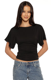Black jersey top with a boat neck, short dolman sleeves, and ruched waist detail