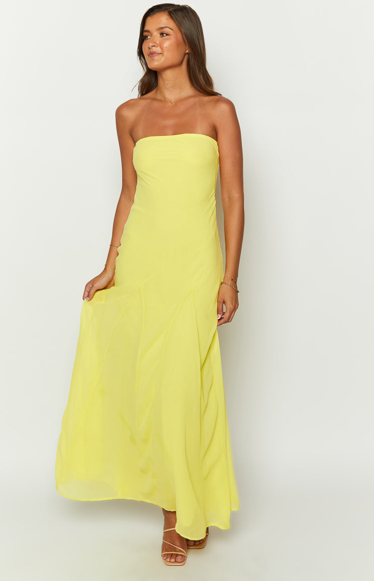 Front view of a yellow strapless maxi dress with a fitted bodice and a flowing skirt with subtle paneling