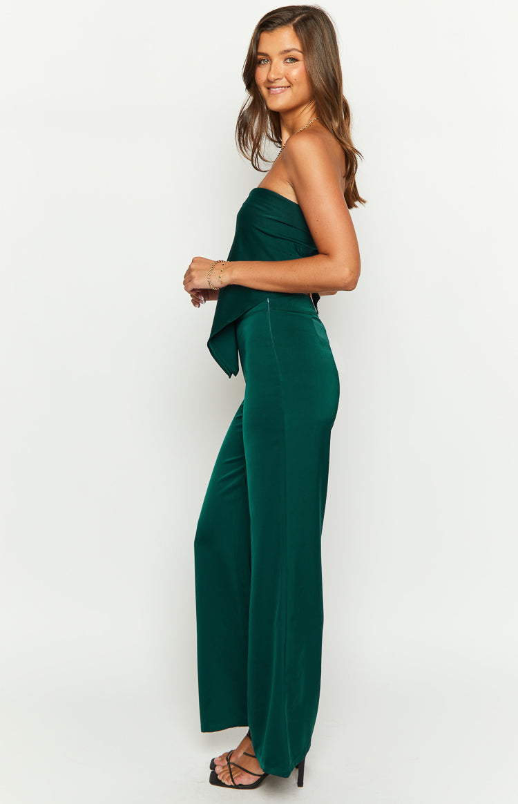 Side view of teal wide-leg pants with a fitted high waist and smooth, flowing fabric