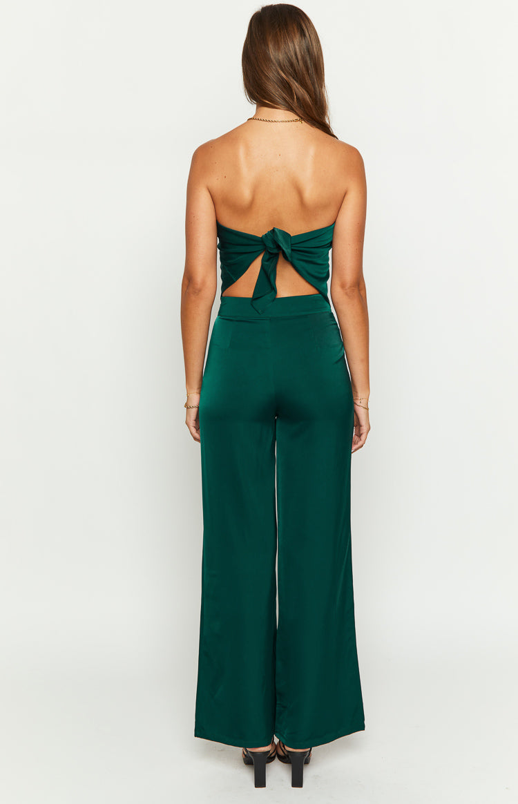 Rear view of teal satin wide-leg pants, showing the smooth, flowing fabric and full length