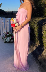 Side view of a flowy pink maxi skirt in a soft fabric, showing its full length and gentle drape