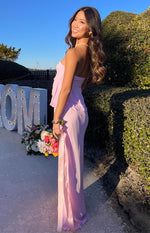 Side view of a pink maxi skirt showing the high side slit and long, flowing silhouette
