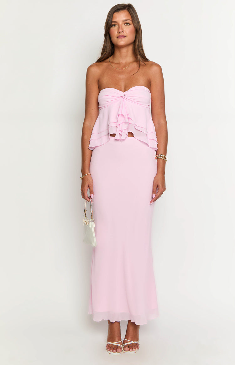 Front view of a light pink maxi skirt with a smooth, fitted waist and a flowing, slightly sheer hem