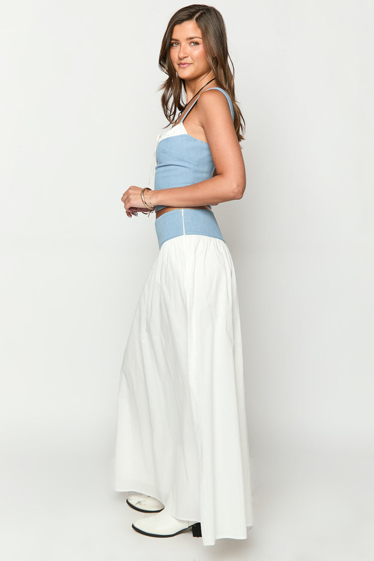 Side view of a white maxi skirt with a wide light blue denim-look waistband and flowy silhouette