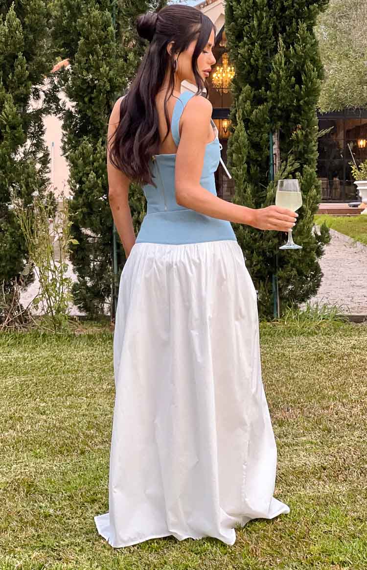 Side view of a white maxi skirt with a gathered waist and a full, flowy silhouette