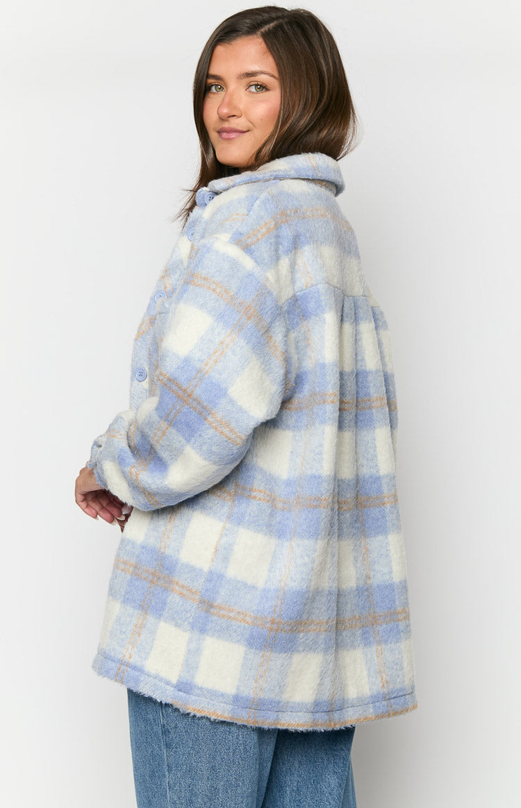 Side view of a blue and white plaid jacket with a relaxed, oversized fit and dropped shoulder seams