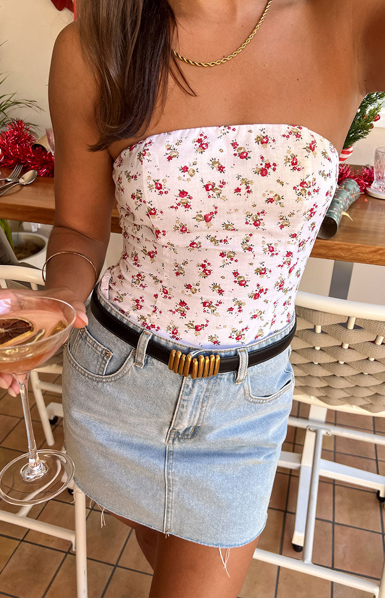 Fitted white strapless top with a delicate red and green floral print