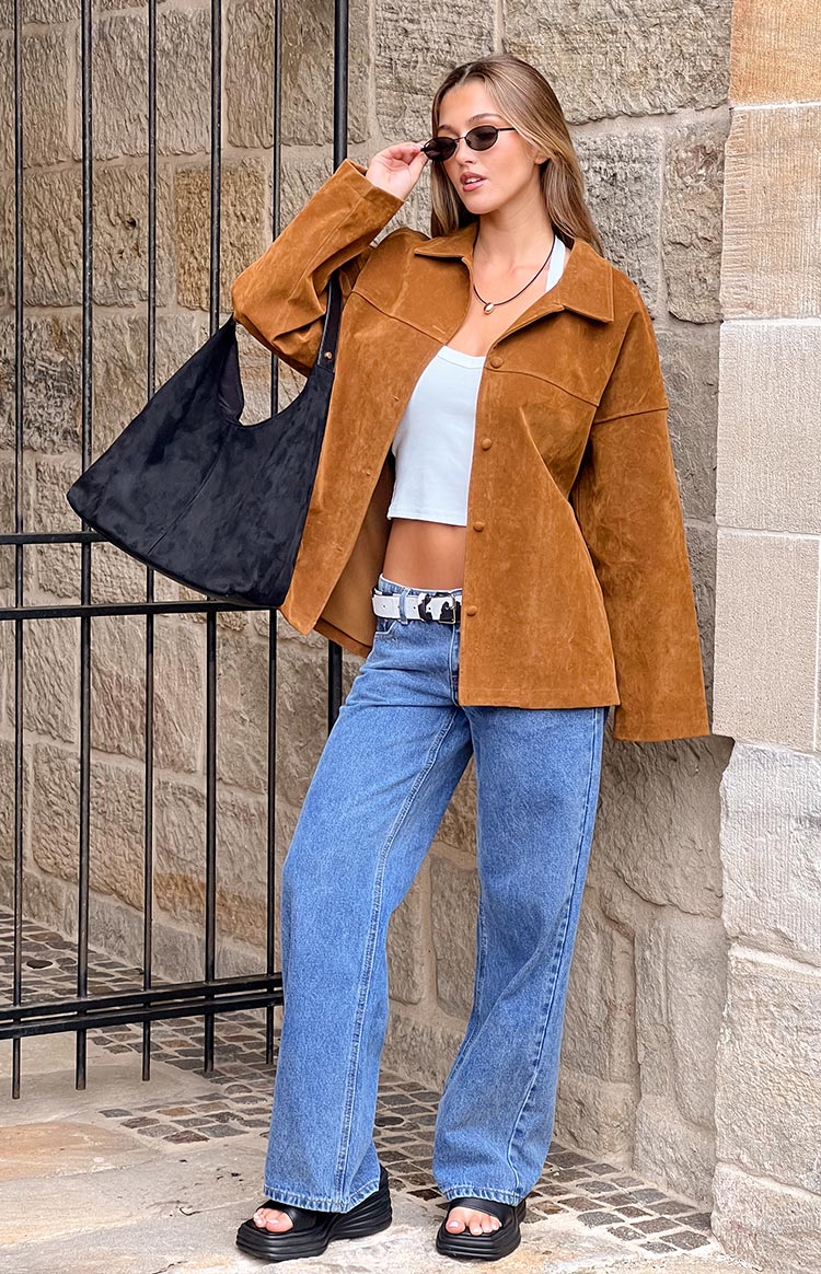 Tan suede oversized jacket with a pointed collar and long sleeves, showing its relaxed fit