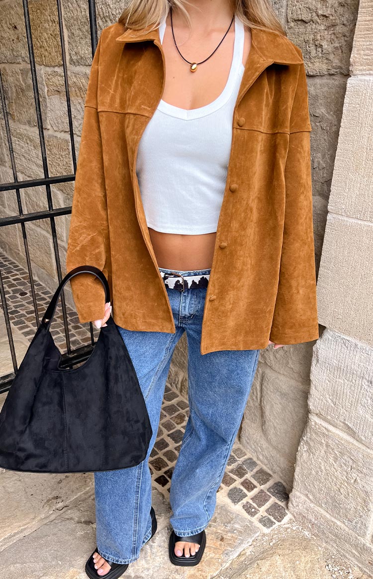 Tan suede oversized jacket with a collared neckline and long sleeves, showing the soft texture and relaxed drape
