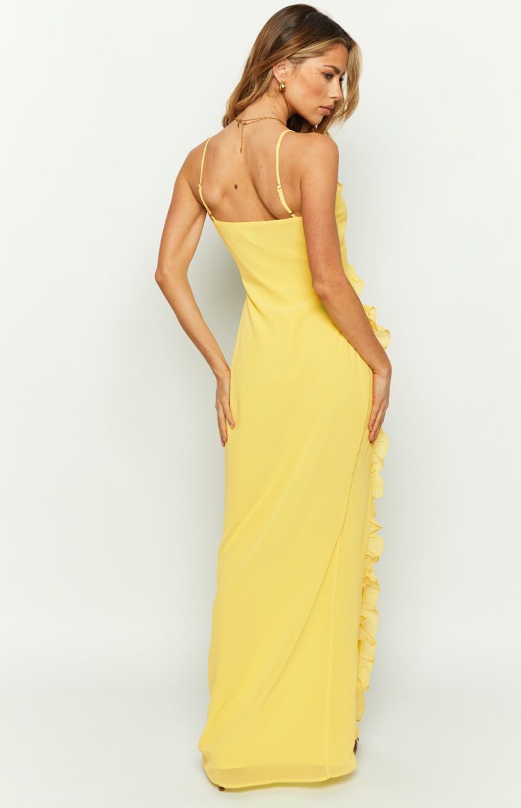 Side view of a yellow maxi dress showing thin spaghetti straps and a full-length ruffle detail
