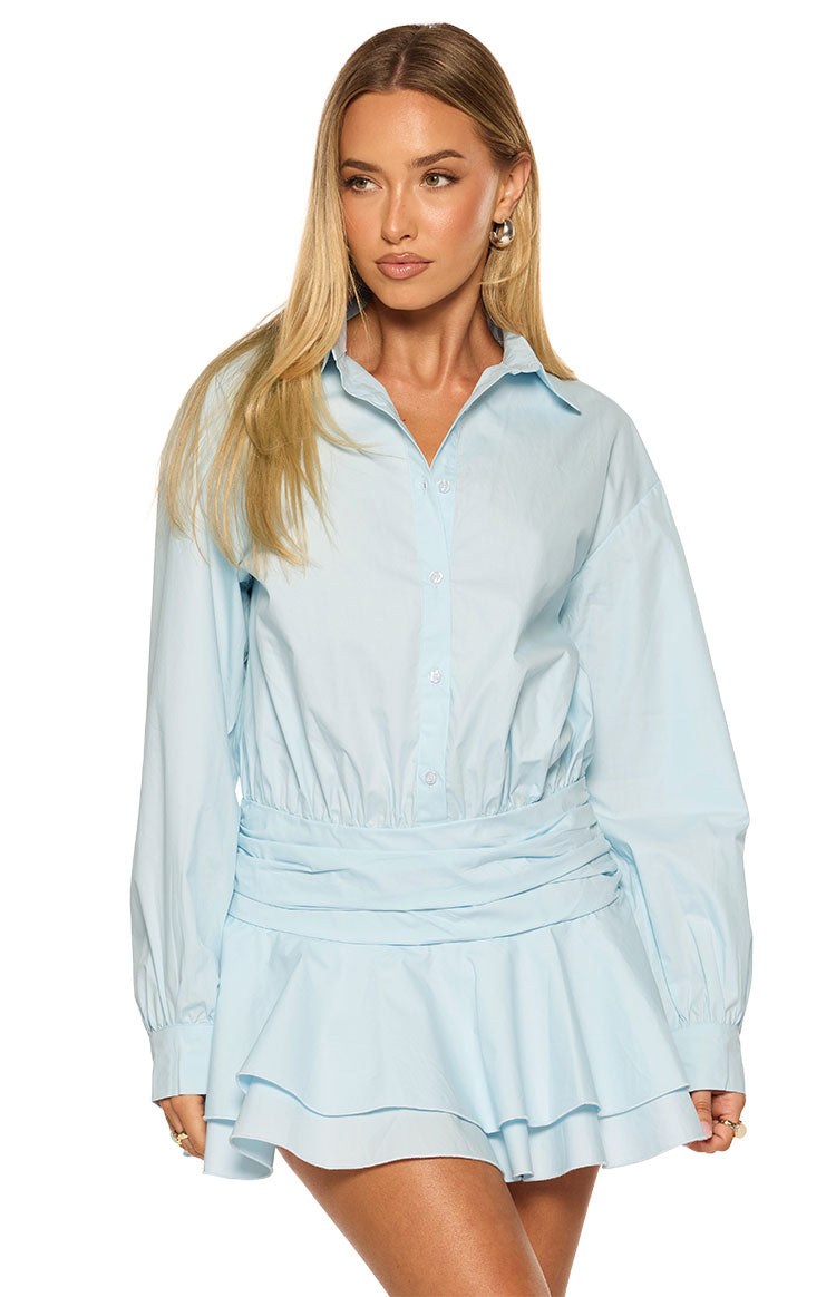 Light blue long sleeve mini shirt dress featuring a collared button-front and shirred elastic waist with ruched band