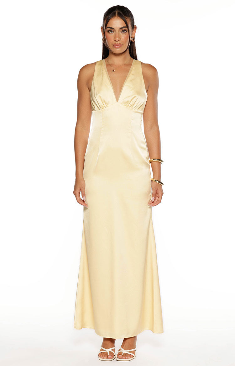 Front view of a yellow satin maxi dress with a deep V-neck, ruched bust, and flowy A-line skirt