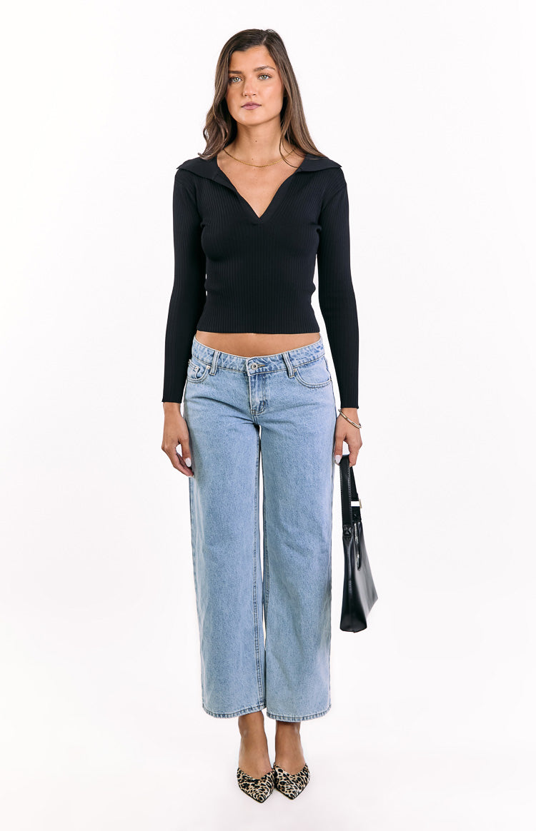 Black ribbed knit long sleeve sweater with a V-neck collar and a cropped hemline