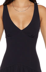 Close-up of the deep V-neckline, fitted bodice with subtle gathering, and side zipper of a navy crepe maxi dress